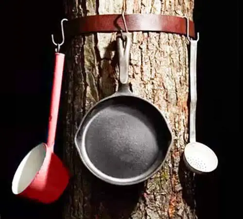 hang pots and pans on a tree while camping using a belt